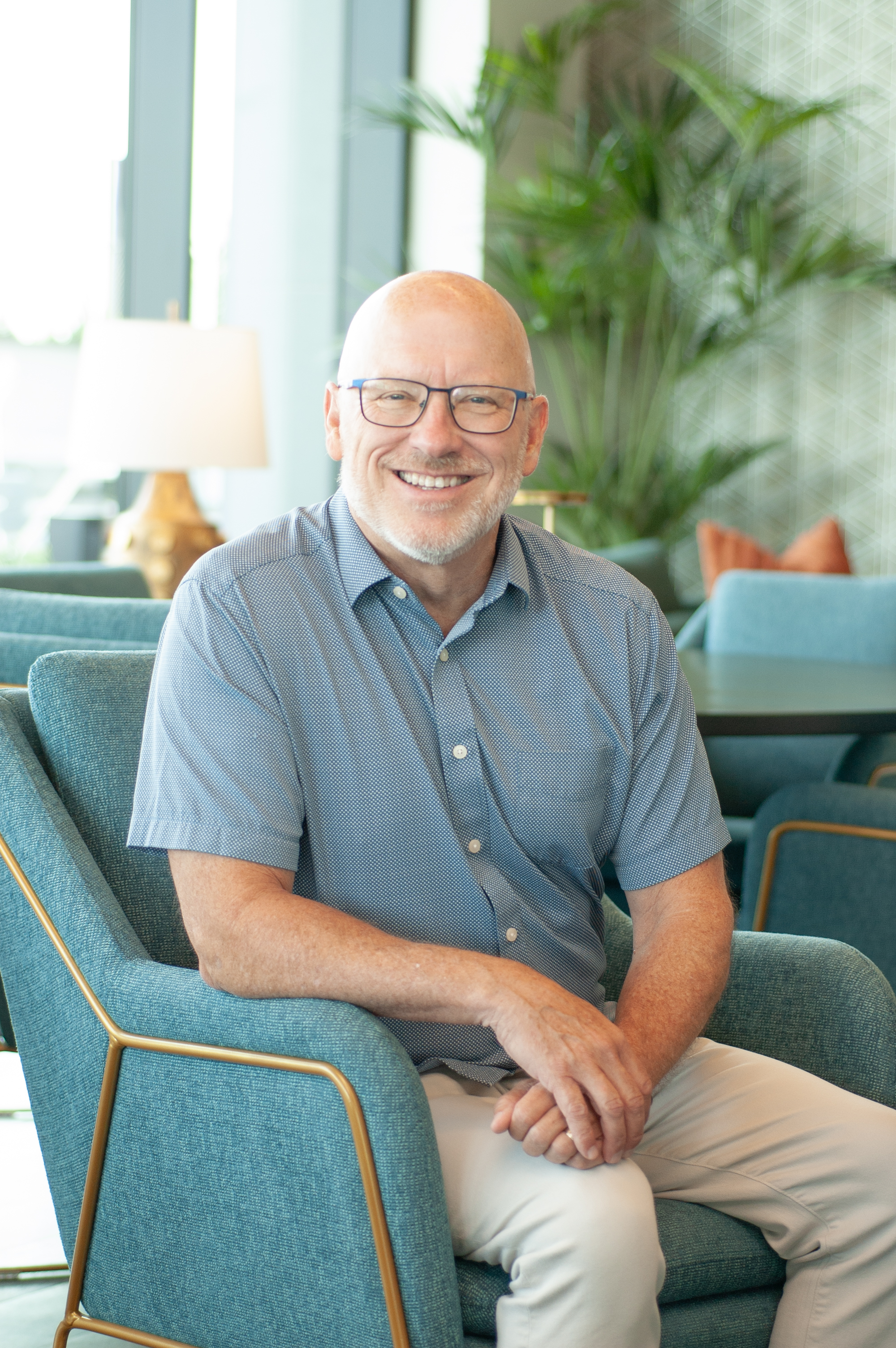 Dr. Brett Blair smiling in a modern lounge